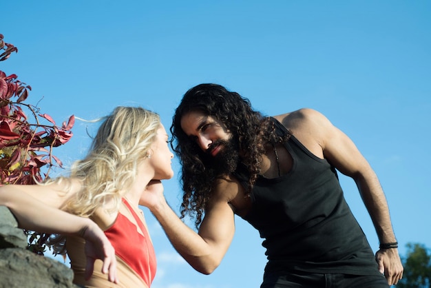 Joven pareja romántica enamorada de pasar tiempo al aire libre Fuerte y guapo hombre barbudo tocando su novia