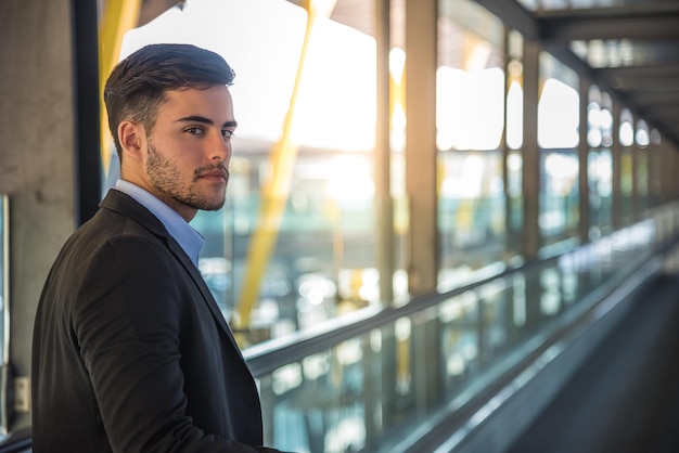 Foto joven en la pasarela del aeropuerto mirando a la cámara