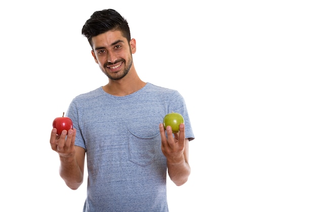 Joven persa sosteniendo manzana roja y manzana verde