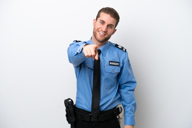 Un joven policía caucásico aislado de fondo blanco te señala con una expresión de confianza