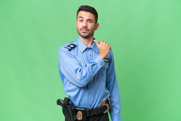 Foto joven policía caucásico sobre un fondo aislado orgulloso y satisfecho de sí mismo