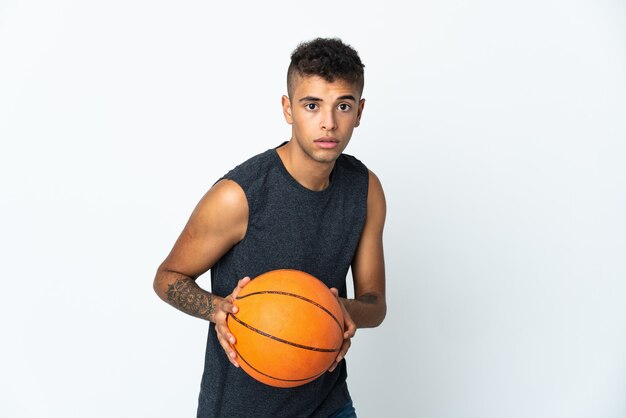 Joven posando aislado contra la pared en blanco