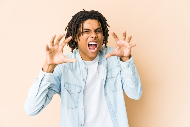 Joven rasta afroamericano mostrando garras imitando a un gato, gesto agresivo.