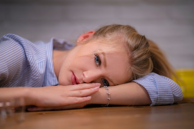 joven rubia acostada en una mesa