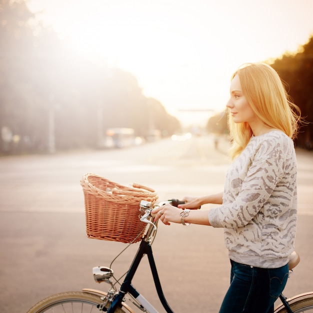 Joven rubia en una bicicleta vintage