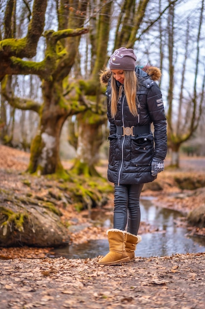 una joven rubia en un bosque en otoño