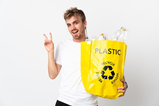 Joven rubia sosteniendo una bolsa de reciclaje llena de papel para reciclar aislado