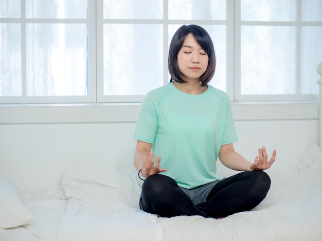 Joven sonriente atractiva mujer yogui practicando yoga