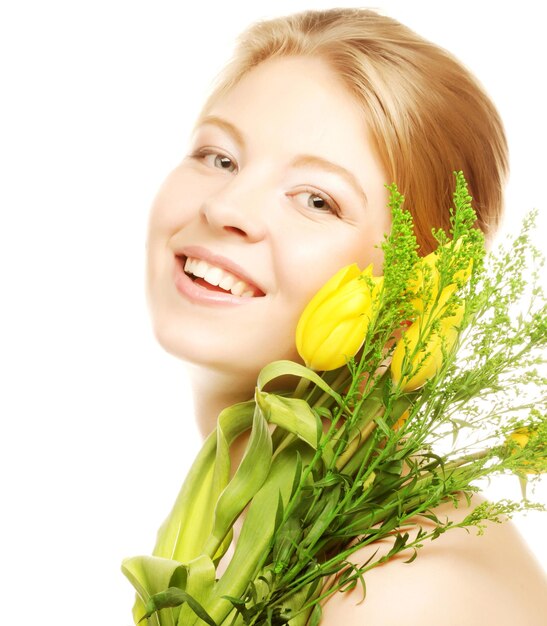 Joven sonriente con tulipanes amarillos