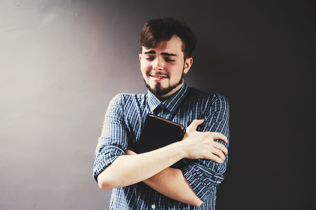 Foto joven sosteniendo una biblia, estudiante con libro