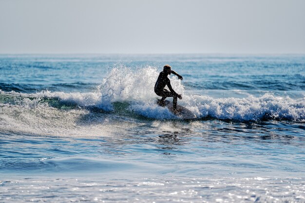 joven, surfear, las olas, en, el, océano pacífico