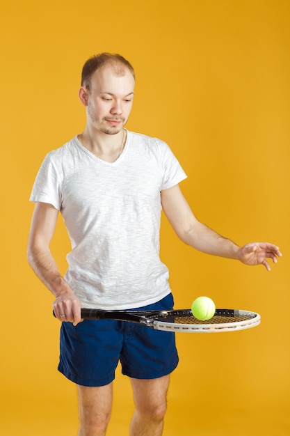 Joven tenista juega al tenis en un amarillo