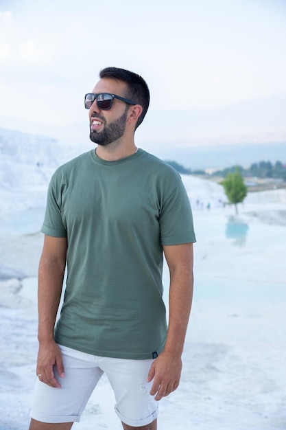 Joven turista posando alegremente en los castillos de algodón de Pamukkale