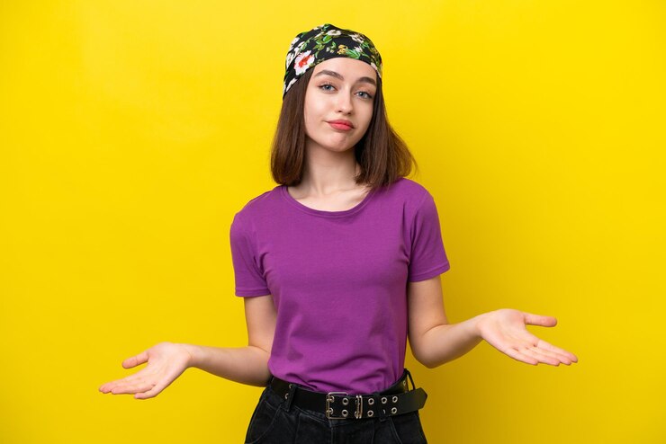 Foto joven ucraniana aislada de fondo amarillo con dudas