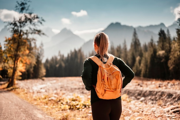 Joven viajero chica de senderismo con mochilas Senderismo en la naturaleza Estado de ánimo al atardecer Paisaje soleado Bielovodska walley eslovaquia Altos tatras