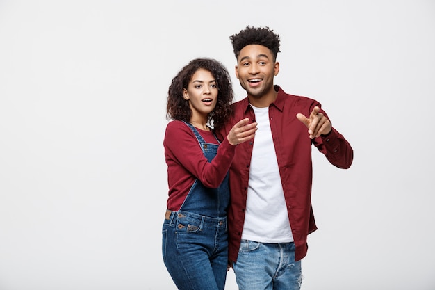 Jóvenes afroamericanos en ropa casual mirando a otro lado y señalar el dedo.