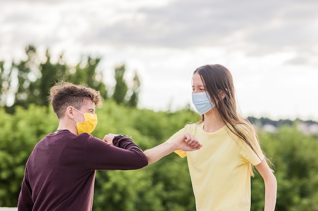 Jóvenes amigos que se encuentran con distanciamiento social por el estilo de vida del coronavirus amistad con máscara