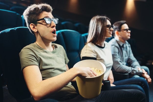 Jóvenes amigos viendo películas en 3D en el cine juntos. Showtime, tecnologías de la industria del entretenimiento