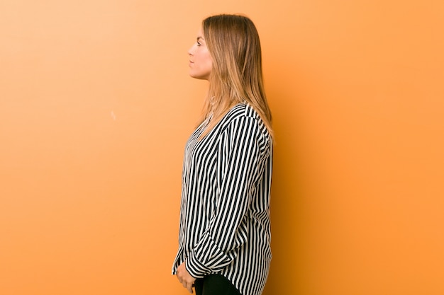 Jóvenes auténticos carismáticos personas reales mujer contra una pared mirando a la izquierda