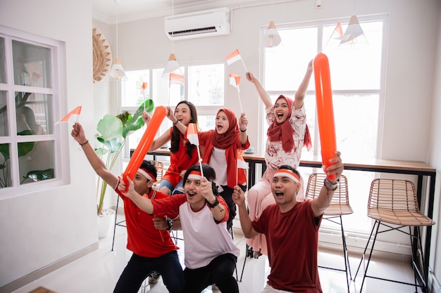 Foto jóvenes indonesios celebrando el día de la independencia nacional vistiendo de rojo y blanco