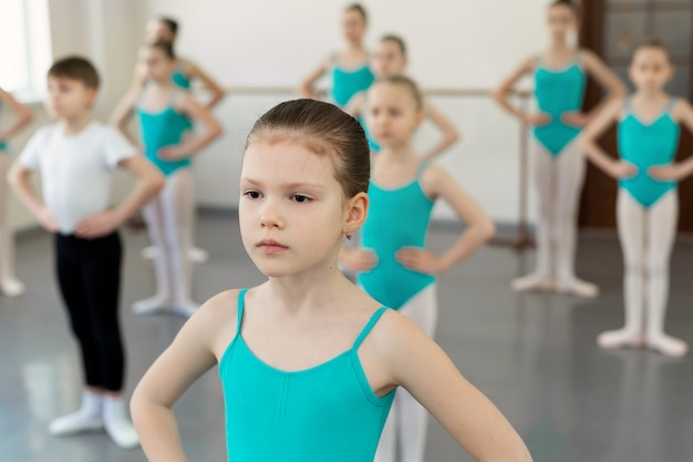 Jóvenes muchachas de ballet en leotardos practicando en la clase de ballet