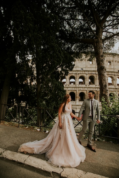 Jóvenes novios por el Coliseo en Roma, Italia