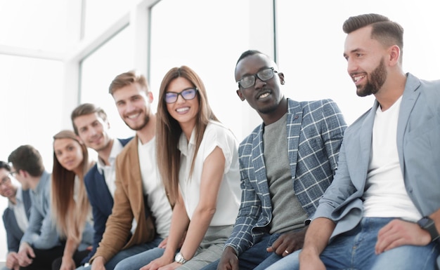 Jovens sentados na parede esperando sua vez na entrevista o conceito de emprego