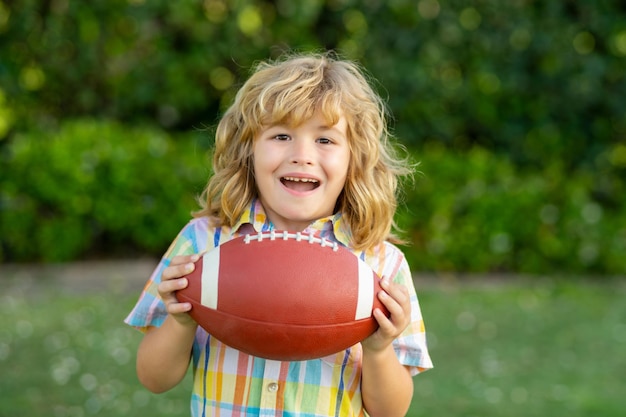 Juego de fútbol rugby fútbol americano chico con pelota de rugby niño chico jugando fútbol al aire libre