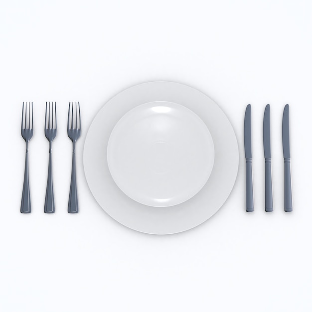 Juego de mesa para una cena de tres platos sobre una superficie blanca