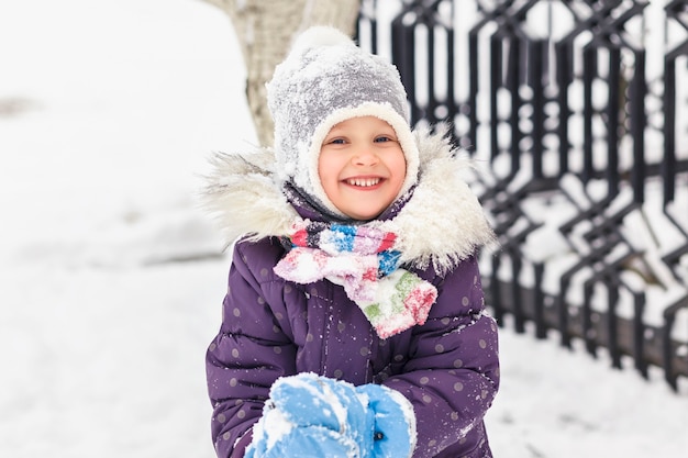 Juego de nieve de niño en ropa de invierno.