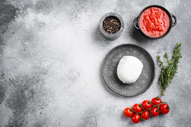 Juego de queso mozzarella tradicional, sobre fondo de mesa de piedra gris, vista superior plana, con espacio de copia para texto