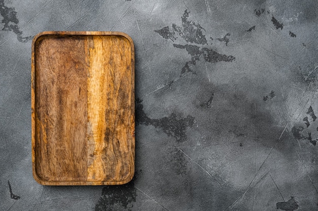 Juego de tablas para cortar o servir con paleta, vista superior plana, con espacio para copiar texto o su producto, sobre fondo de mesa de piedra gris