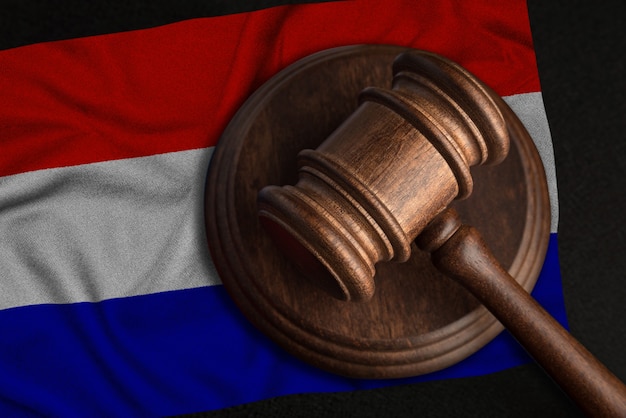 Juez Martillo y bandera de Holanda. Ley y justicia en Holanda. Violación de derechos y libertades.