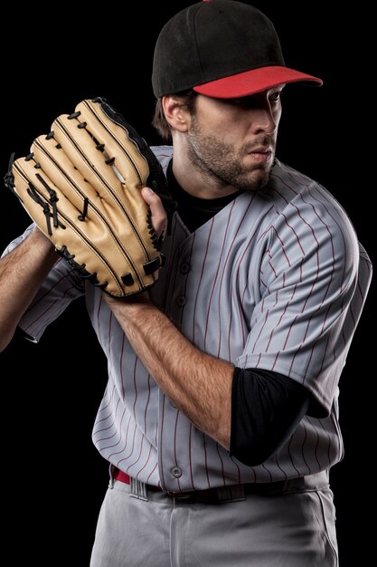 Jugador de béisbol lanzando una pelota. Foto de estudio.