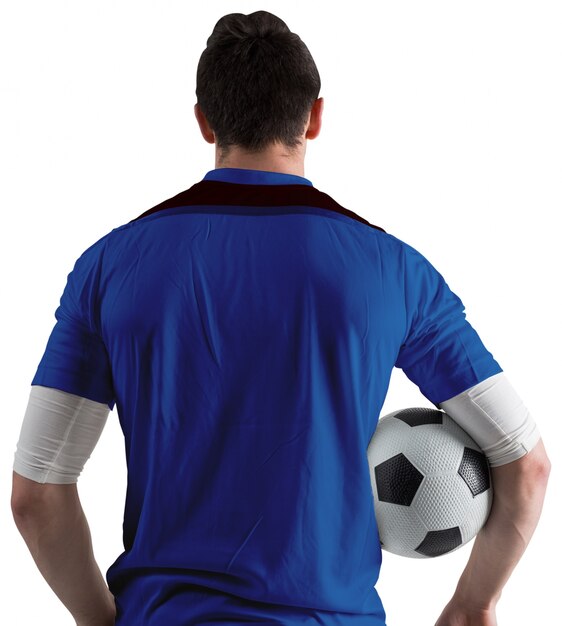 Foto jugador de fútbol en bola azul holding