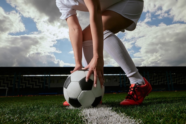 Foto el jugador de fútbol coloca la pelota en el campo de fútbol al comienzo del partido de fútbol