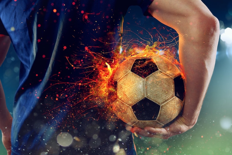 Foto jugador de fútbol listo para jugar con una pelota de fútbol de fuego
