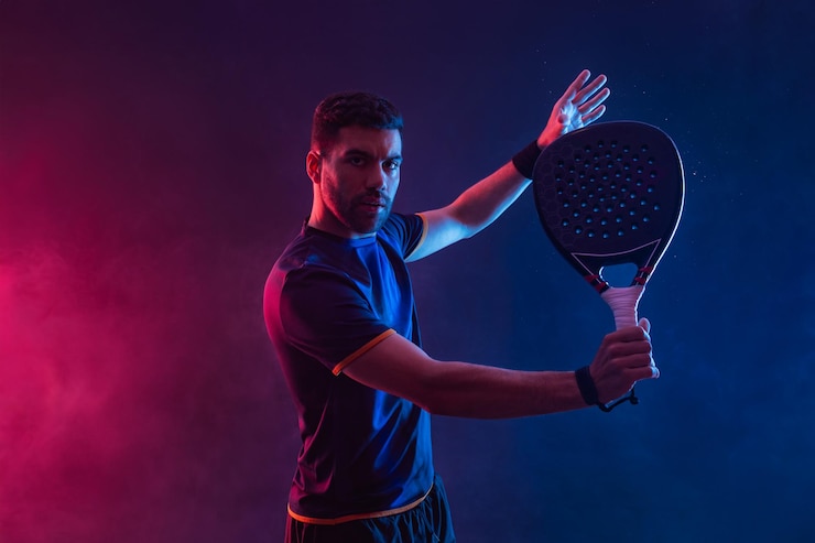 Foto jugador de tenis de padel hombre atleta con raqueta de tenis de paleta en fondo de neón concepto deportivo descargar un