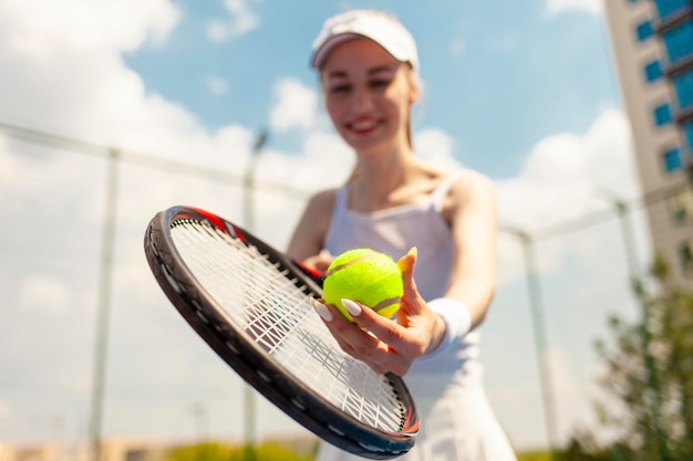 jugadora de tenis de uniforme blanco sosteniendo una raqueta en la cancha de tenis atleta femenina jugando al tenis