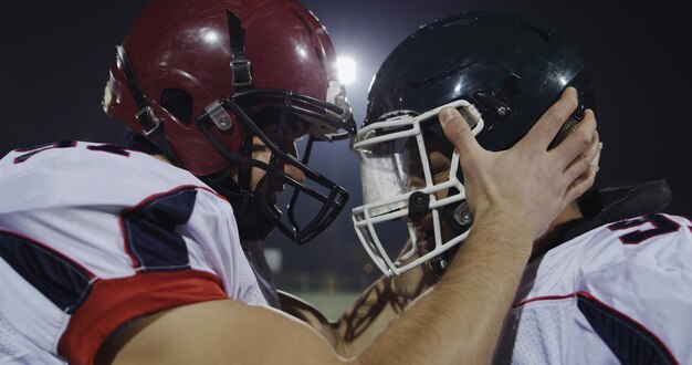 Jugadores de fútbol americano divirtiéndose y golpeándose con casco