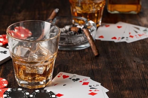 Jugar al póquer con whisky y puros en la mesa