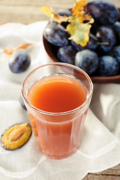 Jugo de ciruela en un vaso con frutas frescas