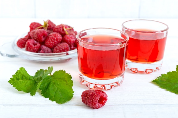 Jugo de frambuesa en vasos y bayas frescas