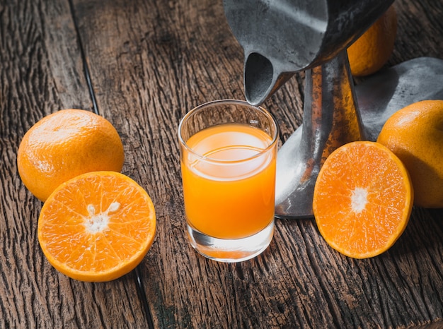 Foto jugo de naranja sobre una mesa de madera