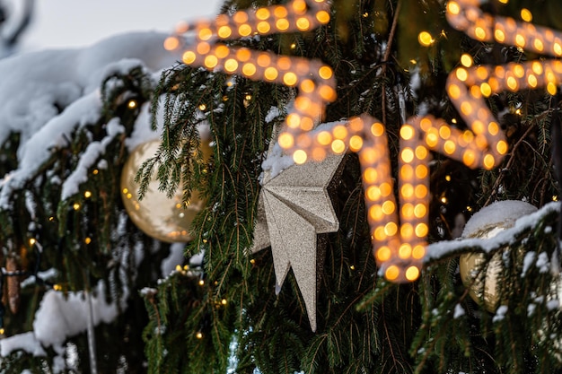 Juguetes de Navidad en el árbol de Navidad Nieve en una rama Decoración de la calle en invierno