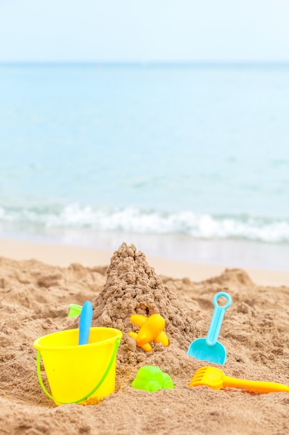 Juguetes para niños areneros contra el mar y la playa
