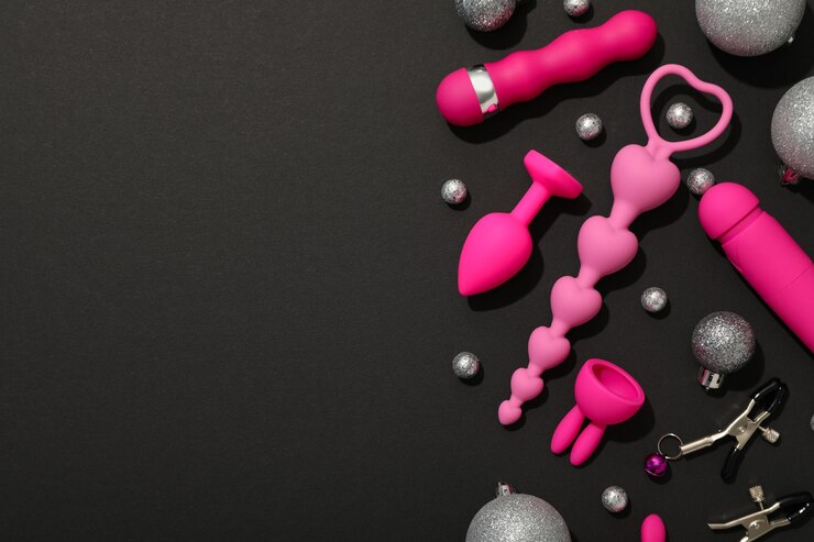 Juguetes sexuales con adornos navideños sobre un fondo oscuro