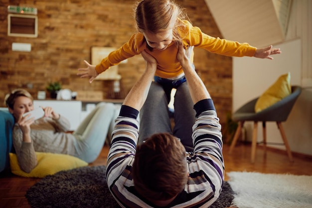 Juguetón padre e hija divirtiéndose en casa