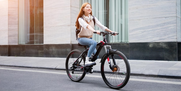 Junge asiatische Frau mit Fahrrad als Transportmittel