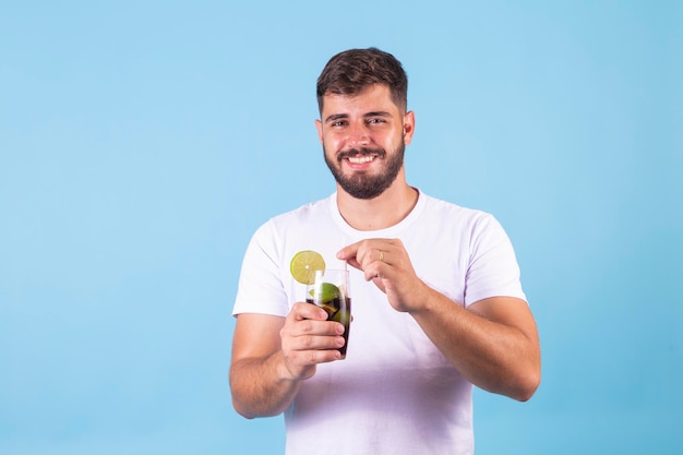 Junge, der eine Cola in einem Glas trinkt